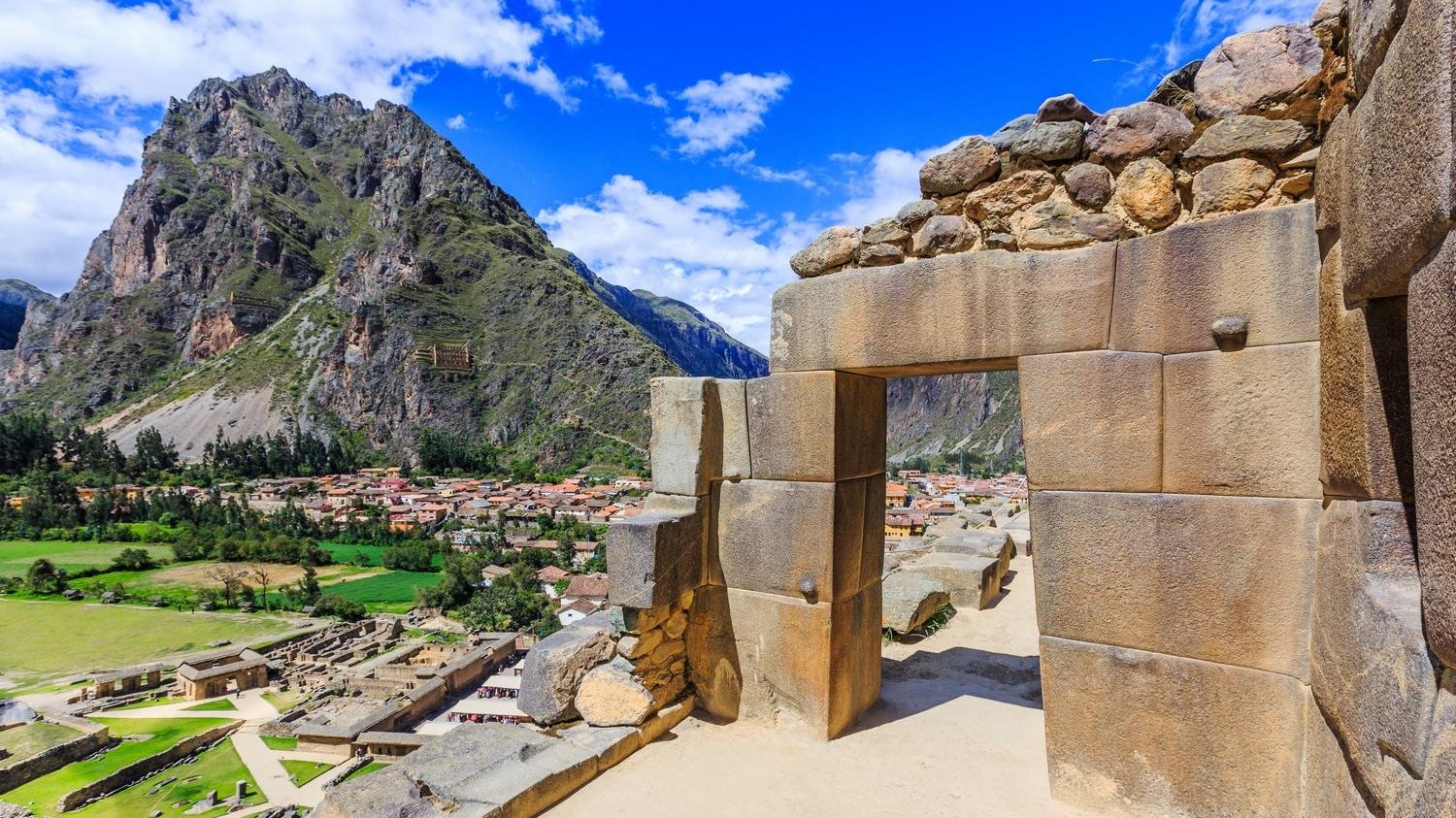 Inca doorway at Ollantaytambo fortress overlooking Sacred Valley town on the Sacred Valley and Machu Picchu Tour
