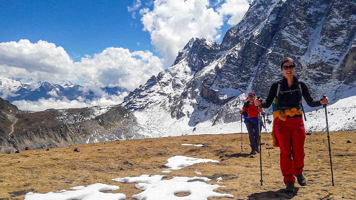 Hiker reaching Salkantay Pass at 4630 meters with glacier views on the 3 day Salkantay Express trek